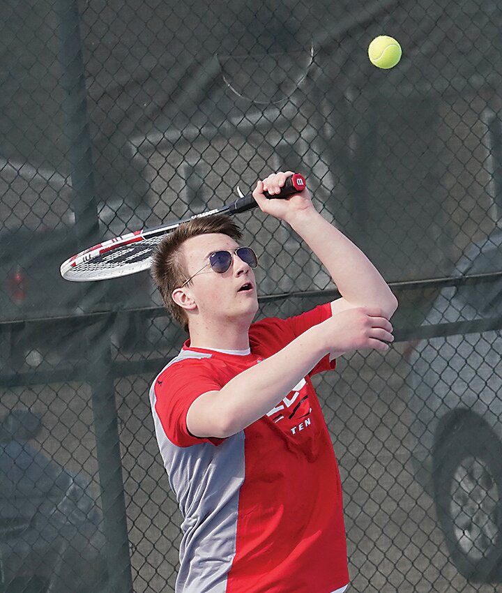 ELC&rsquo;s Elijah Masters sends up a serve during his first varsity start in Monday&rsquo;s match against Storm Lake.