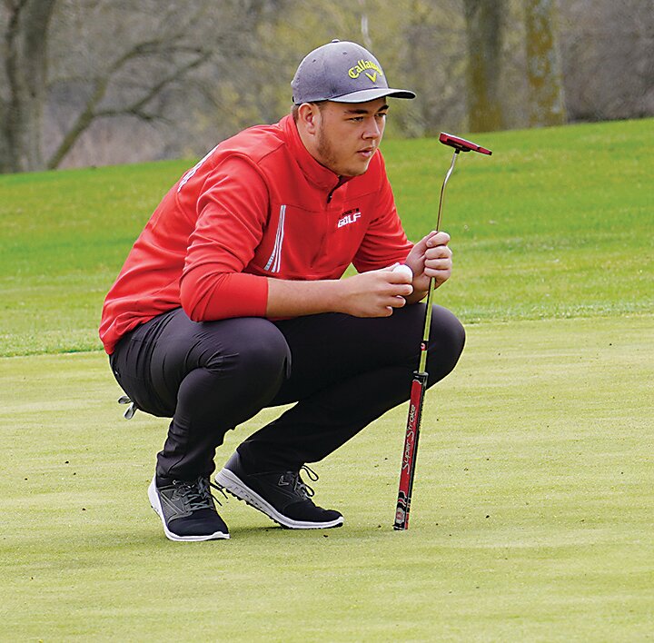 ELC&rsquo;s Carter Ingvall checks the route to the hole on green No. 3  at the Estherville Golf Course on Monday.