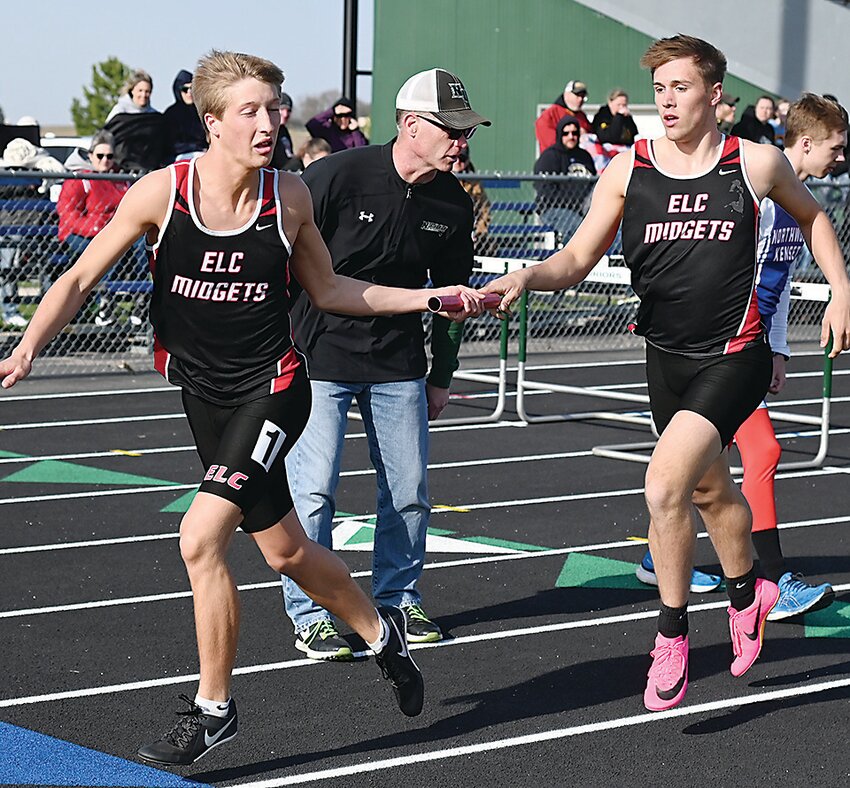 ELC’s Warren Duitsman makes the handoff to Conner Matheson in the 4x800-meter relay at last Thursday’s meet in Armstrong.