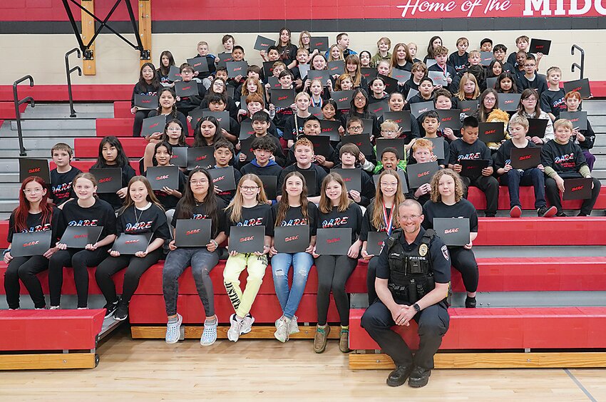 Estherville Captain Nate Dunlavy, front, poses with the 2024 D.A.R.E. Class at Estherville Lincoln Central. The program is taught to fifth graders at ELC in an effort to warn students of the perils of drugs and alcohol.