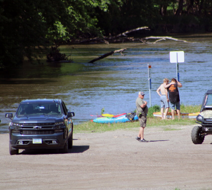 Rescue workers provide assistance at the staging point for a water rescue on the West Fork, Des Moines River on Saturday afternoon. Emergency personnel were dispatched to the area to respond to a flipped kayak with a child stuck on a log jam.