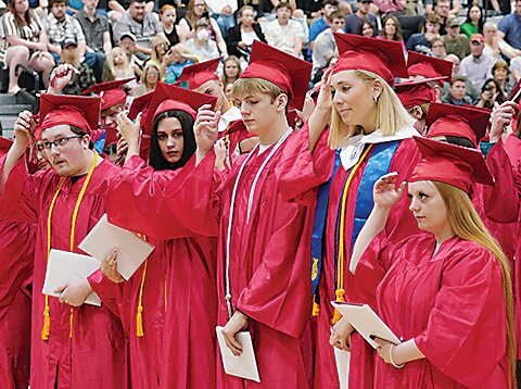 Front from left, Andrew Bethune, Emerson Blair, Blake Bresler, Shelby Brosh and Savannah Burrow move their tassels to indicate they are now graduates of Estherville Lincoln Central High School following Sunday’s commencement.