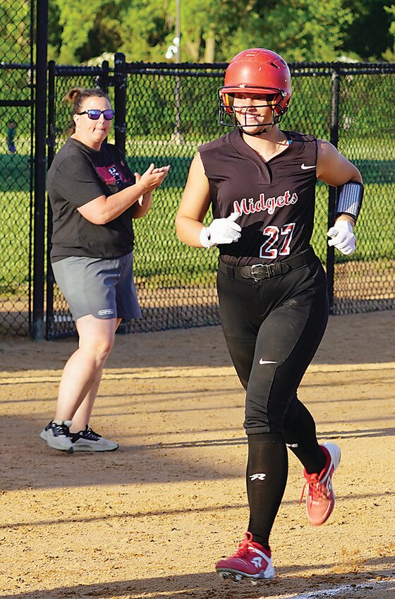ELC head coach Megan Anderson applauds as Hillary Ruschy jogs home after the junior hit a grand slam for the Midgets’ first hit of the 2024 season last Wednesday, May 22 against Graettinger-Terril/Ruthven-Ayrshire.
