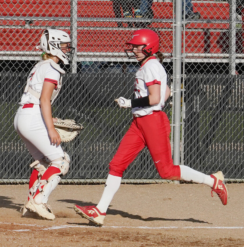 After a pick-off attempt at third base went awry, Estherville Lincoln Central’s Haylee Stokes trots home for the Midgets’ third run against Spirit Lake on Monday. The ELC junior hit her second home run of the season later in the game.