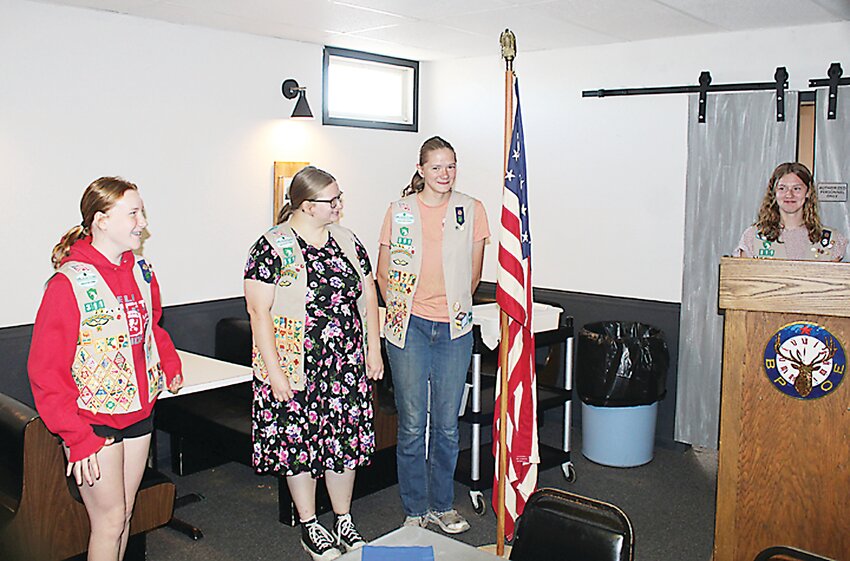 Helen Lavender, Austin Lavender, Cassandra Harvey, and Bristol Friesner from Girl Scout Troop 314 presented the flag.