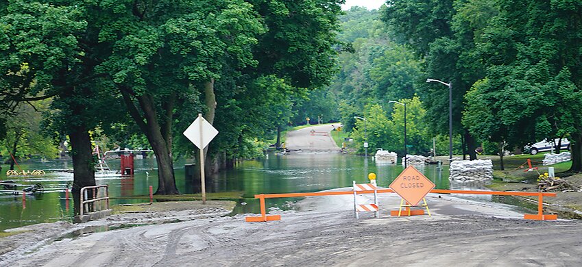 Flood waters still covered West First Street in Estherville, both south (above) and north of Iowa Highway 9. Motorists should turn around when roads are flooded.