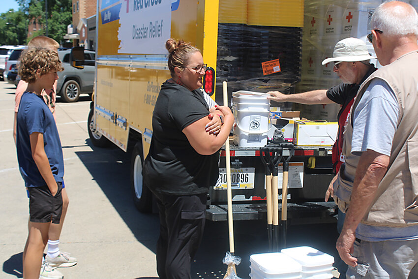 Cassidy Hatland of Estherville, her son and a friend stopped by the Red Cross relief truck Sunday afternoon to gather supplies for cleanup at the Hatland home. Find more information on the Red Cross on Page 3A of today’s Estherville News.