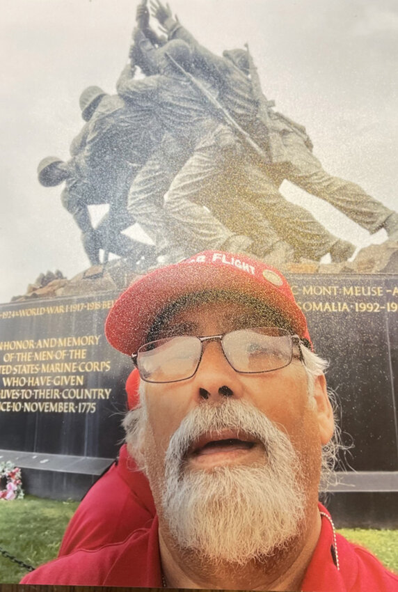 Richard Baker stood in front of the Iwo Jima monument. Baker learned that an earlier flag raising took place, but wasn’t photographed, so the group of soldiers depicted here raised another flag.