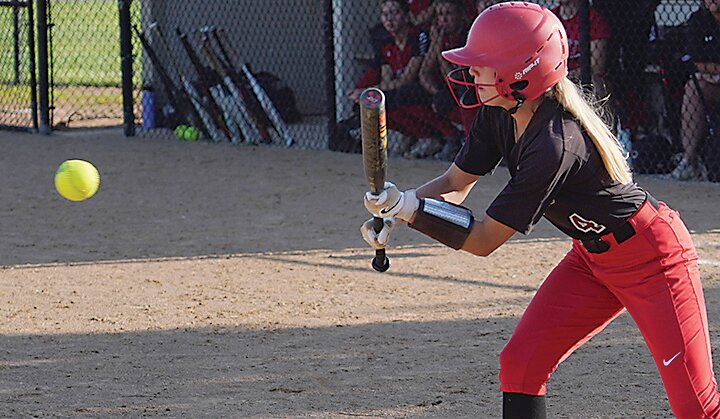 ELC&rsquo;s Kacie Brechwald laid down a sacrifice bunt during the Midgets game against North Polk on Monday.
