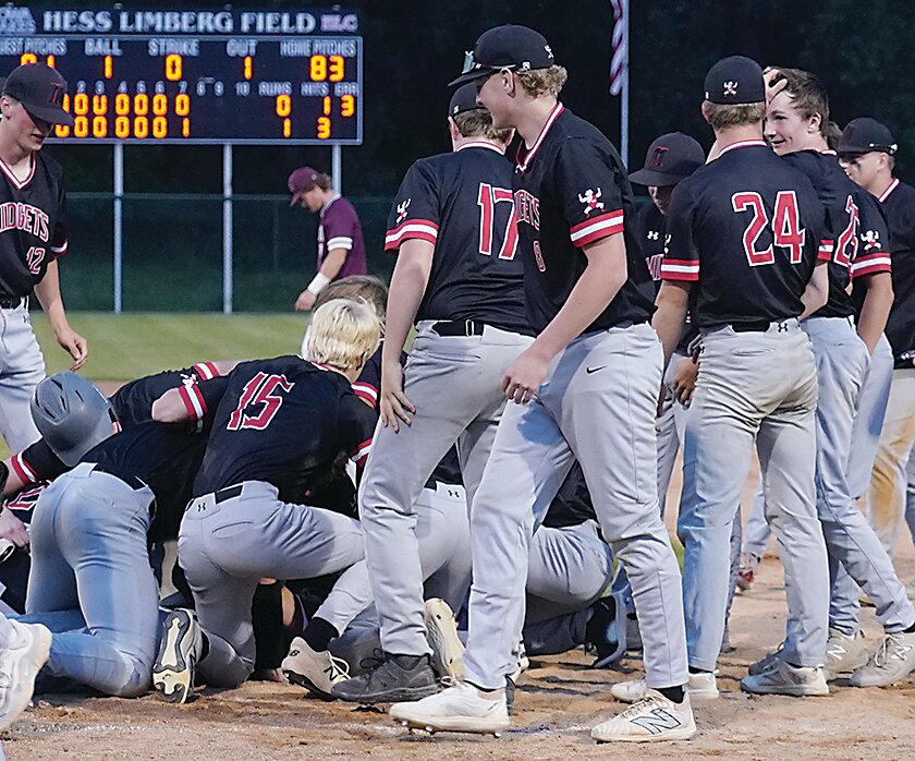 ELC players swarmed Layton Yager after the sophomore drove in the game&rsquo;s only run against Okoboji on Tuesday. The Midgets advance to Saturday&rsquo;s Class 2A District Final against rival Spirit Lake. Game time is 7 p.m. in Estherville.