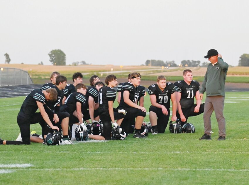 The North Union Football Team takes a knee while assistant coach Robert Zotz talks to them as they wait to see the outcome of their injured quarterback Grady Madden. Madden received a season-ending injury in the first few minutes of the homecoming game against Belmond-Klemme.