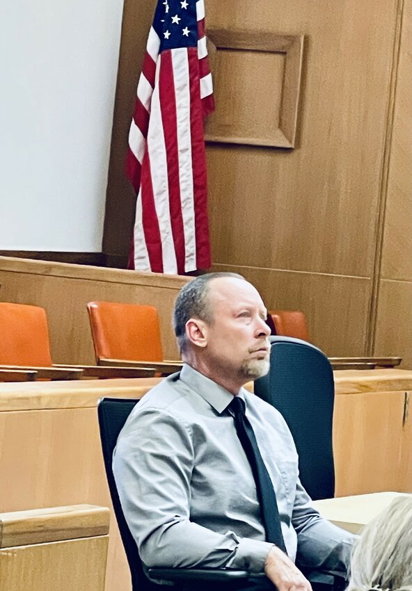 Craig Merrill of Armstrong awaits sentencing in Emmet County District Court Tuesday morning. Merrill was supported in court by his parents and his wife, Danielle.