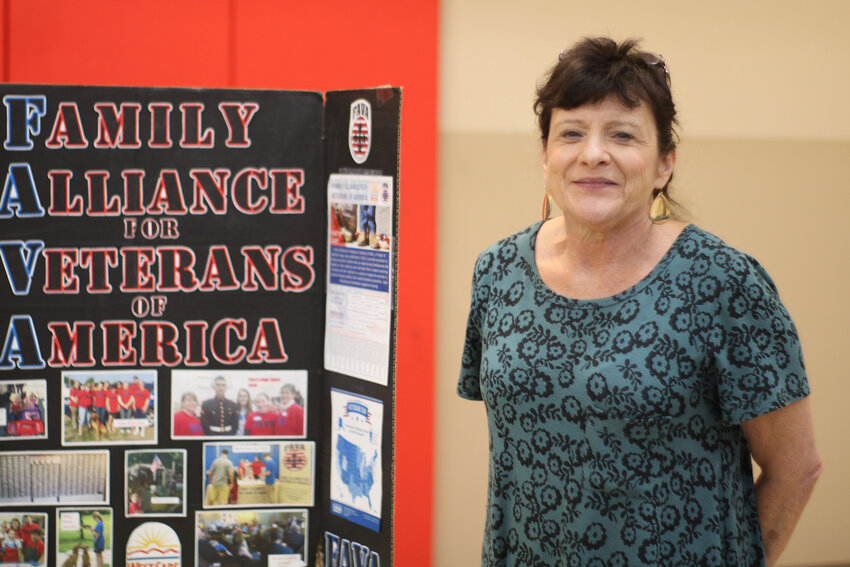 Rose Holmes of Westcare shows a display of the services provided by FAVA and related organizations to veterans and their families experiencing homelessness.