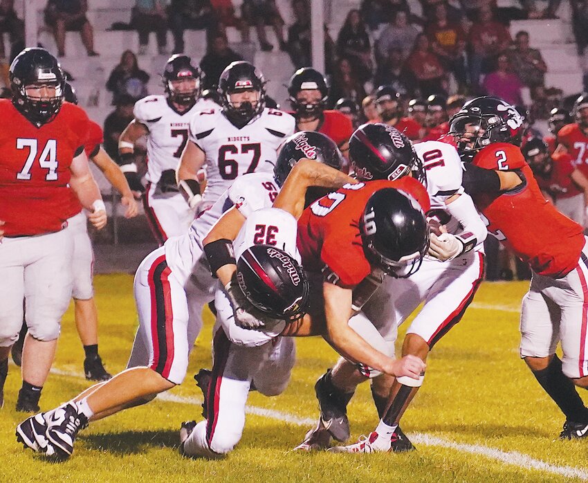 ELC’s Noah Danner (55), Kale Shatto (32) and Sincere McMurran (10) make this tackle early in Friday’s game against Clarion-Goldfield-Dows in Clarion.