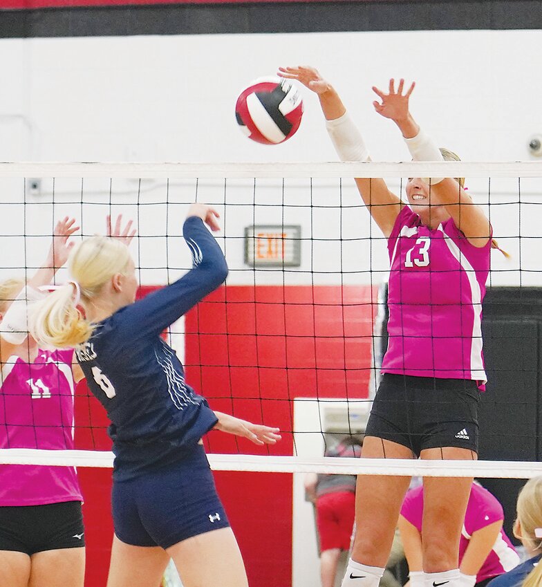 ELC’s Haley Nissen (13) comes up with a block against Jackson County Central on Monday.