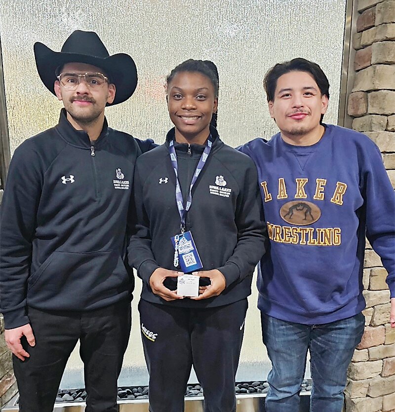 Keyahna Phillips, middle, is the first All-American for the Iowa Lakes Women’s Wrestling Program. The program is in its second season. Pictured with Phillips are head coach Corey Muniz and graduate assistant coach Juan Diaz.