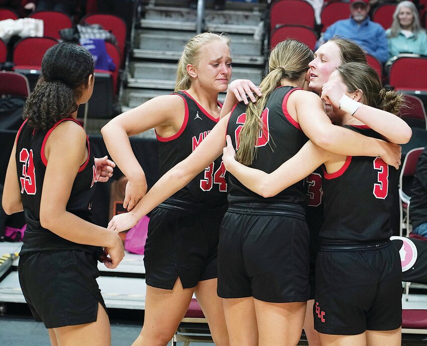 Estherville Lincoln Central seniors gather for one final hug at the conclusion of their careers following Thursday’s 35-34 loss to Mount Vernon in the Class 3A State Basketball semifinal.