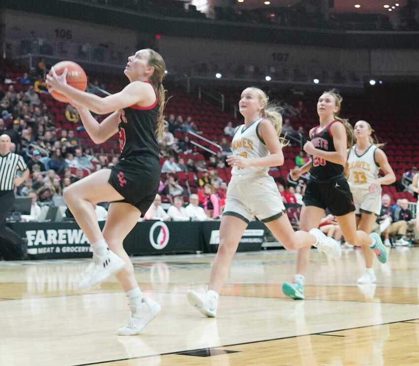 Above, Estherville Lincoln  Central’s Haylee Stokes goes in for a left-handed layup against Cherokee during the Class 3A State Quarterfinal with teammate Rylee Yager trailing the play. A