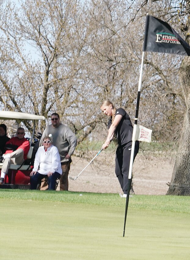 ELC’s Lilly Hecht chips onto the green during a recent meet in Estherville. The sophomore has shown steady improvement throughout the season and had a nine-hole score under 50 in Monday’s tournament at Spencer.