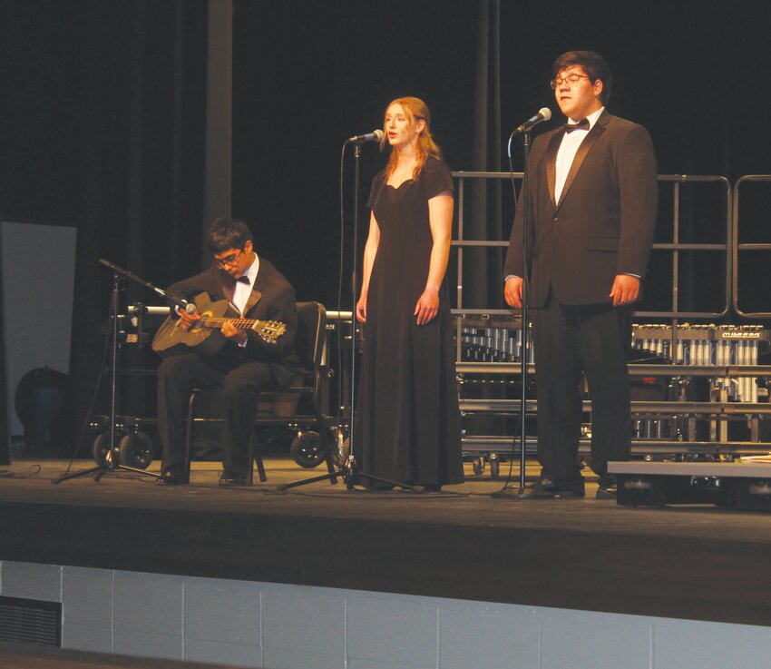 Osvaldo Jiminez Luna, left, Brynn Finley, and Alex Leal presented a song as a parting gift of gratitude for their music teachers.