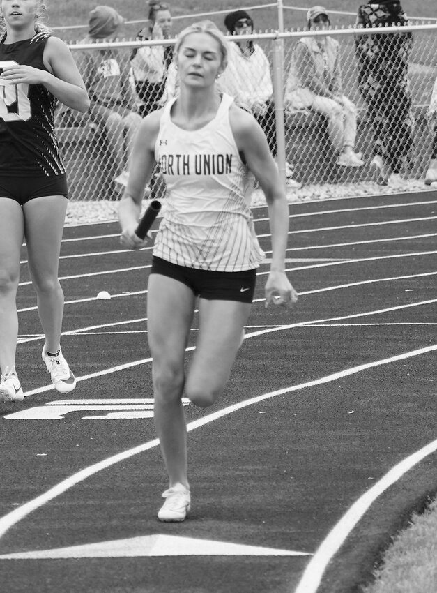 Senior Sienna Hansen runs the second leg of the sprint medley.