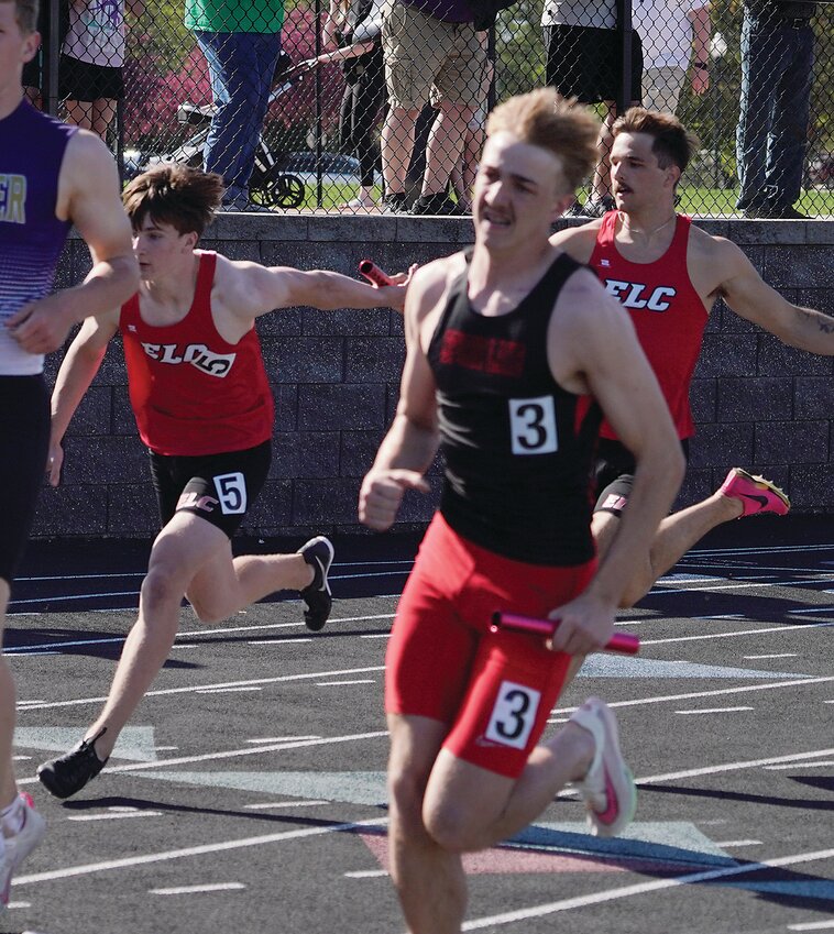 ELC’s Kale Shatto hands off to Garrett Smith at the Lakes Conference meet on May 8. Smith will compete in all three ELC state relays this week while Shatto will be in two.
