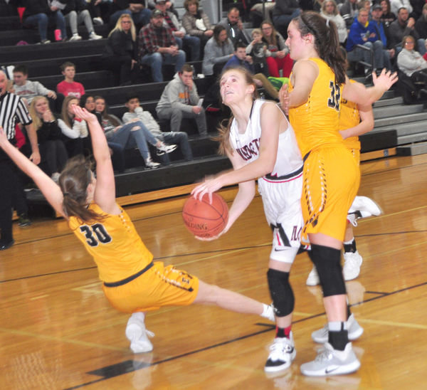 ELC’s Kaitlyn Tendal takes the contact as she drives inside the Emmetsburg defense on Thursday.
Photo by David Swartz