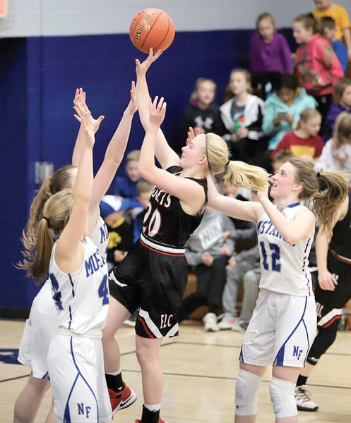 ELC’s Amara Heinrichs (20) sends up a floater in the lane against the Newell-Fonda defense on Thursday.
Photo by Marcy Sander