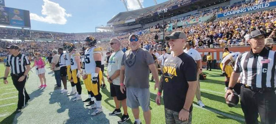 Mike Jensen (looking at camera) and brother Randy Jensen (Iowa t-shirt) were selected honorary captains for the University of Iowa at the Citrus Bowl this past Saturday in Orlando, Fla.
Photo submitted