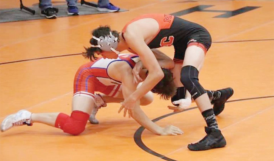 ELC’s Parker Duitsman fends off a shot during wrestling action in Rock Valley last week.
Photo submitted