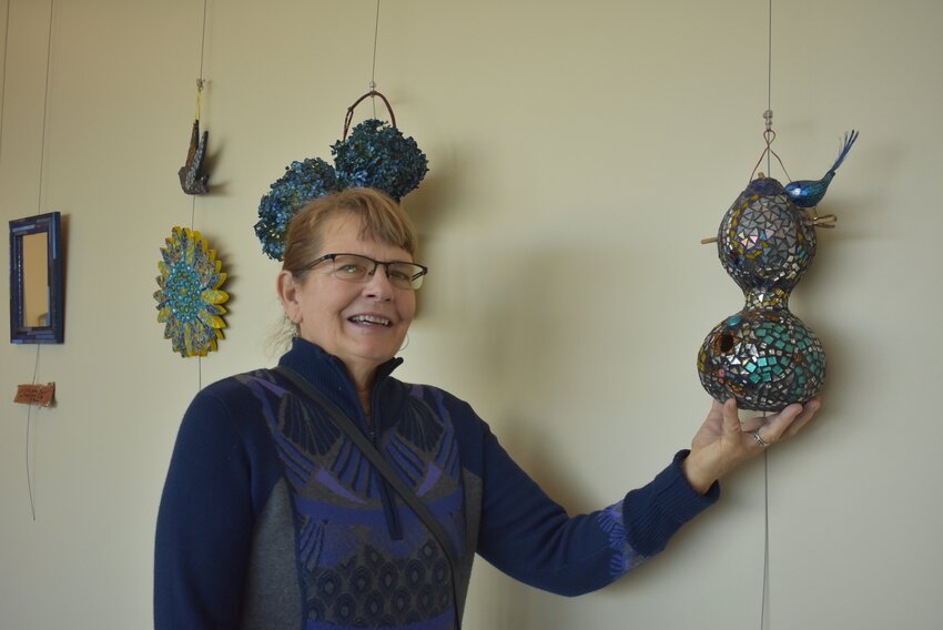 Paige Huber poses with one of her mosaic art pieces, featuring a gourd-turned-birdhouse. Huber’s artwork is on display on the second floor of the Gundersen St. Joseph’s Hospital in Hillsboro.