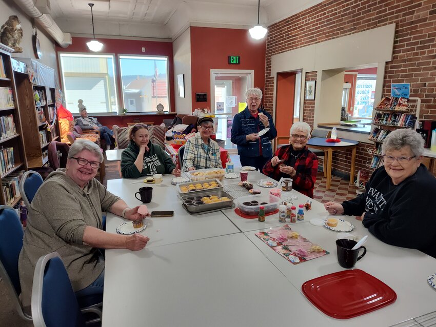 The Kendall Library hosts a variety of programs and events throughout the year. Pictured, left to right, Lynne Hanson, Skip Richie (far back), Gina Trepes, Lynette Vlasak, Carol Bradley, Karen Arzt, and Eileen Richie had a fun and relaxing time decorating cookies and cupcakes at the Kendall Public Library on Friday, February 21.