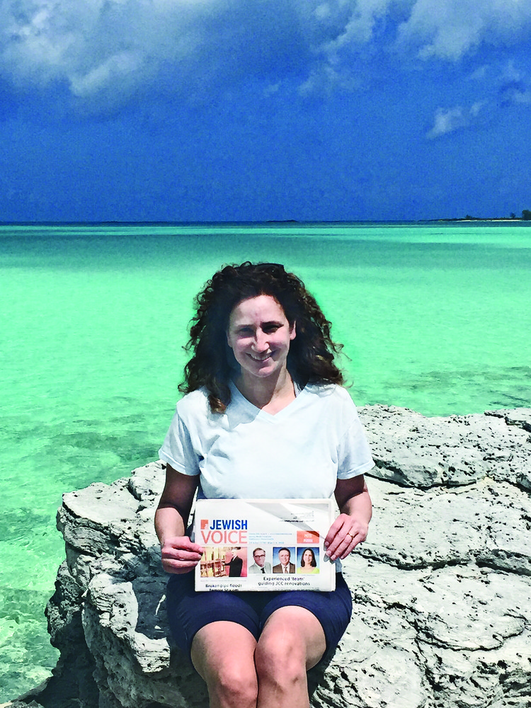 Ellen Jordan, president of Temple Sinai, is catching up with her reading in the Bahamas.