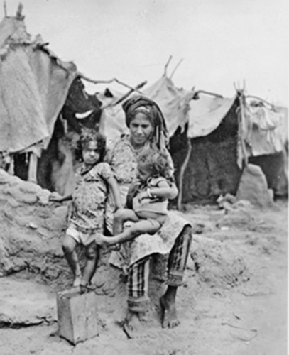Yemenite mother and her two children at a JDC transit camp in the 1950s