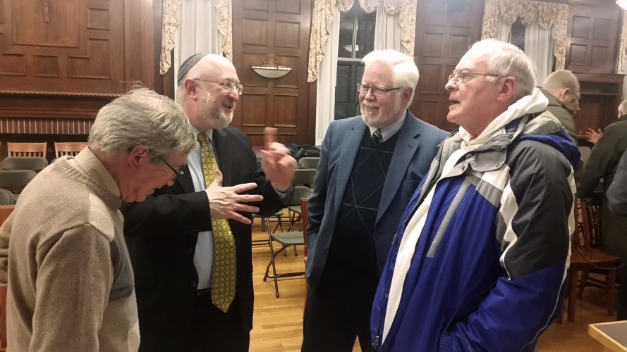 Rabbi Daniel Lehmann and Phil Cunningham, second and third from left, have a conversation with audience members after the event.