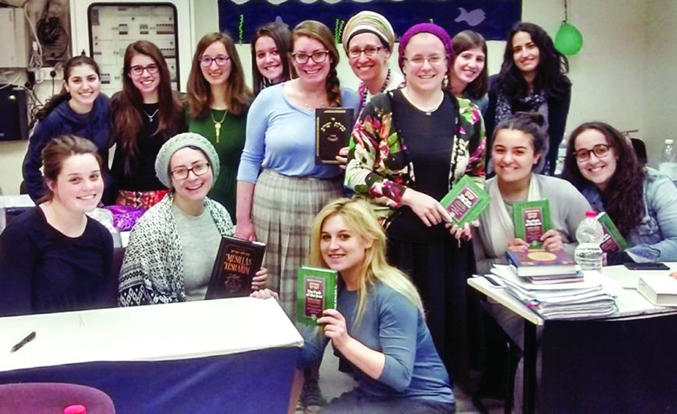 Nava Winkler  with her class as they celebrated finishing a important Jewish book called &ldquo;Path of the Just&rdquo; (&ldquo;Mesillat Yesharim&rdquo;) by Rabbi Moshe Chaim Luzzato. Winkler is in the back row all the way to the right with the dark hair and the scarf near the green balloon.