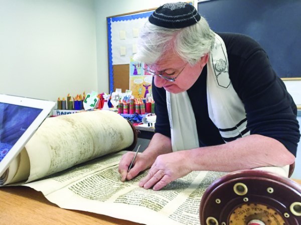 Sofer Neil Yerman as he first pores over and begins to evaluate the damage to the Torah.