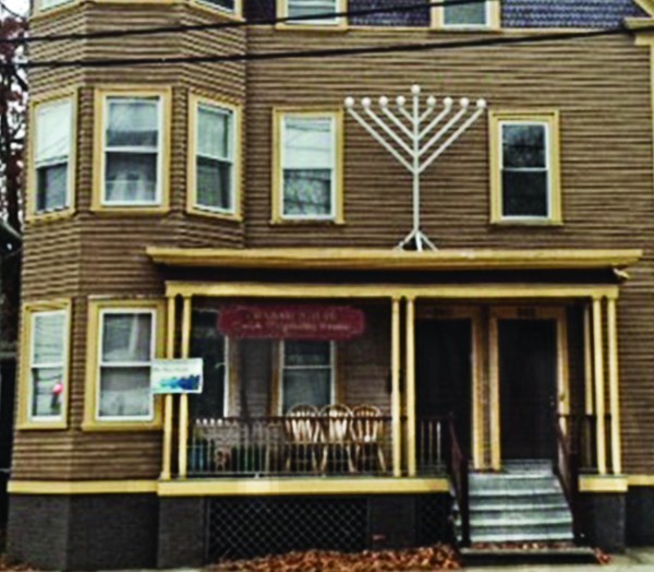 A menorah with straight branches similar to the menorah at the synagogue in Dura Europos outside the Chabad House   in Providence.