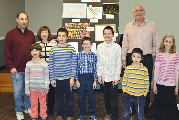 The winners of art and writing contest sponsored by The Jewish Voice and Touro Fraternal Association in front of their entries. For more on the contest, see page 2-3.