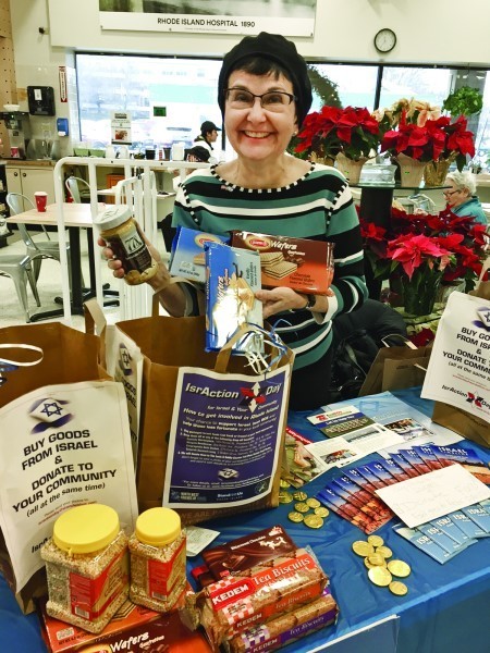 Regina Schild displays the variety of Israeli products collected in the campaign on Dec. 18 which sought to benefit both Israel as well as those less fortunate in Rhode Island.