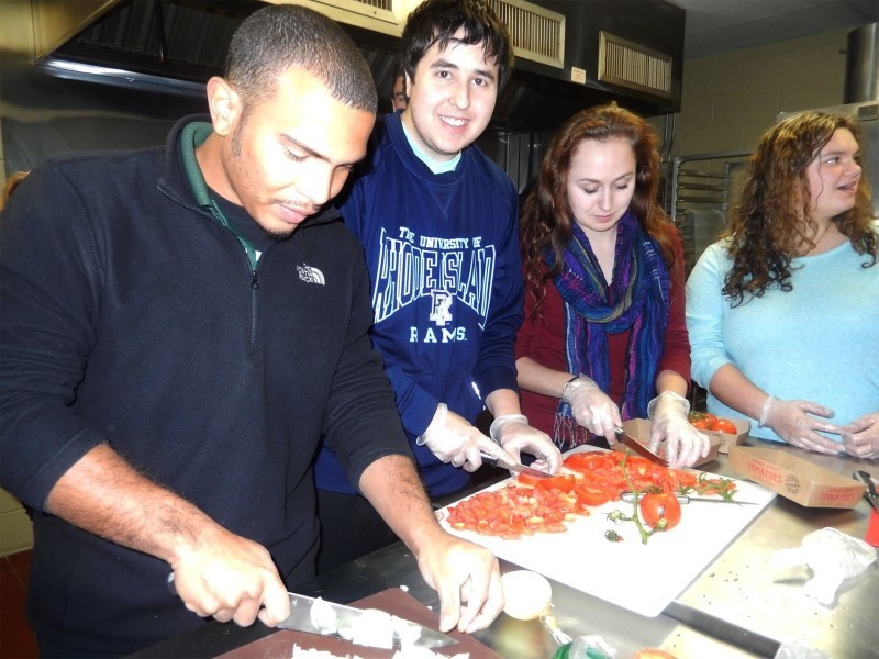 URI students (left to right) Michael Bonilla, Reuven Hoffman, Bridget Holte and Olivia Tagliaferri chop vegetables for the shakshuka before cooking begins.
