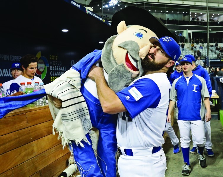 Cody Decker of Team Israel holding team mascot the Mensch on a Bench after the World Baseball Classic game against the Netherlands in Seoul, South Korea, March 9.