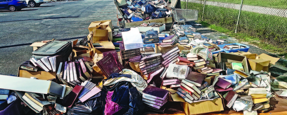 Piles of ruined books from United Orthodox Synagogues of Houston. The congregation lost many of its prayer books and replenished them through donations.