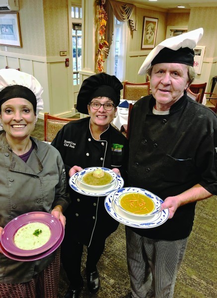 Left: Chef Phyllis Araffa holds a bowl of New England Fish Chowder. Center: Deb Blazer, executive chef, holds a bowl   of chicken soup. Right: Chef Tom Wilcox holds a bowl   of split pea soup.