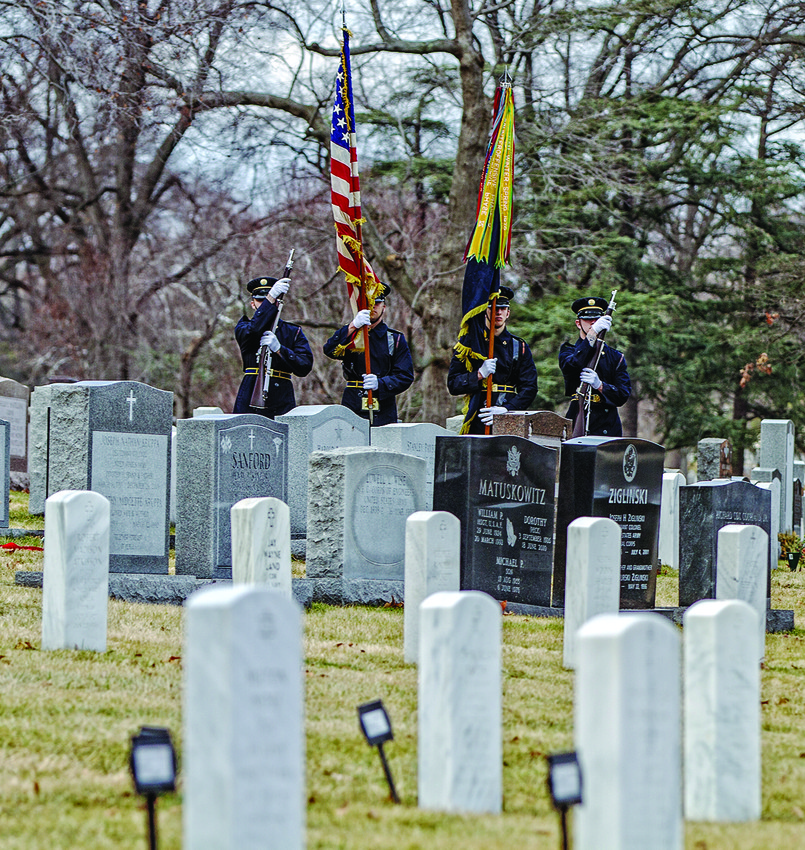 Soldiers salute Lt. Col. Jack Lustig during the   funeral service at Arlington National Cemetery.