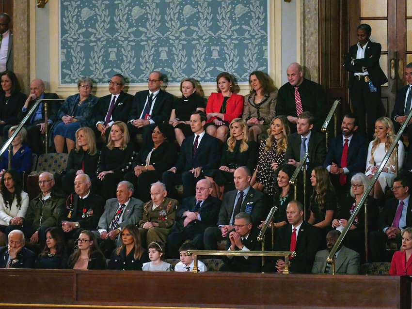 Listening to the State of the Union address in February 2019 are the first family and guests. Melania Trump is in the front row with Buzz Aldrin on her right. In the second row are WW II survivors. In the third row are the Kushners and President Trump's other children.