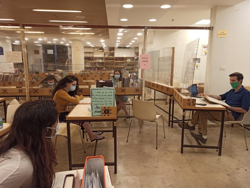 Students at Nishmat in Jerusalem wear masks and are separated by Plexiglas barriers to protect against the coronavirus.