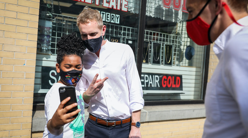 HOLYOKE, MA - AUGUST 26: Mayor Alex Morse of Holyoke takes a selfie with a 10-year-old as he tours downtown Springfield, MA and introduces himself to business owners on Aug. 26, 2020. Days ahead of the Sept. 1 primaries, Morse will challenge Representative Richard Neal in the First Congressional District primary. (Photo by Erin Clark/The Boston Globe via Getty Images)