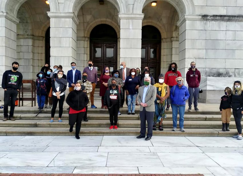 In post-COVID advocacy, September 2020, community advocates gathered outside with masks and social distancing to rally for an equitable state budget.