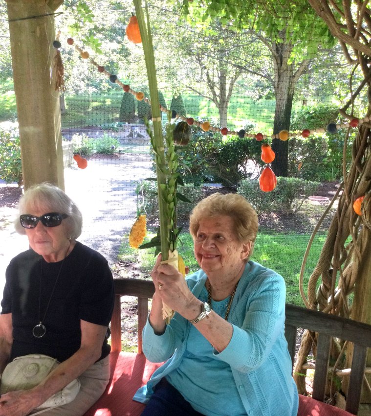 Residents enjoy the sukkah in the garden at the Phyllis Siperstein Tamarisk Assisted Living Residence in Warwick.